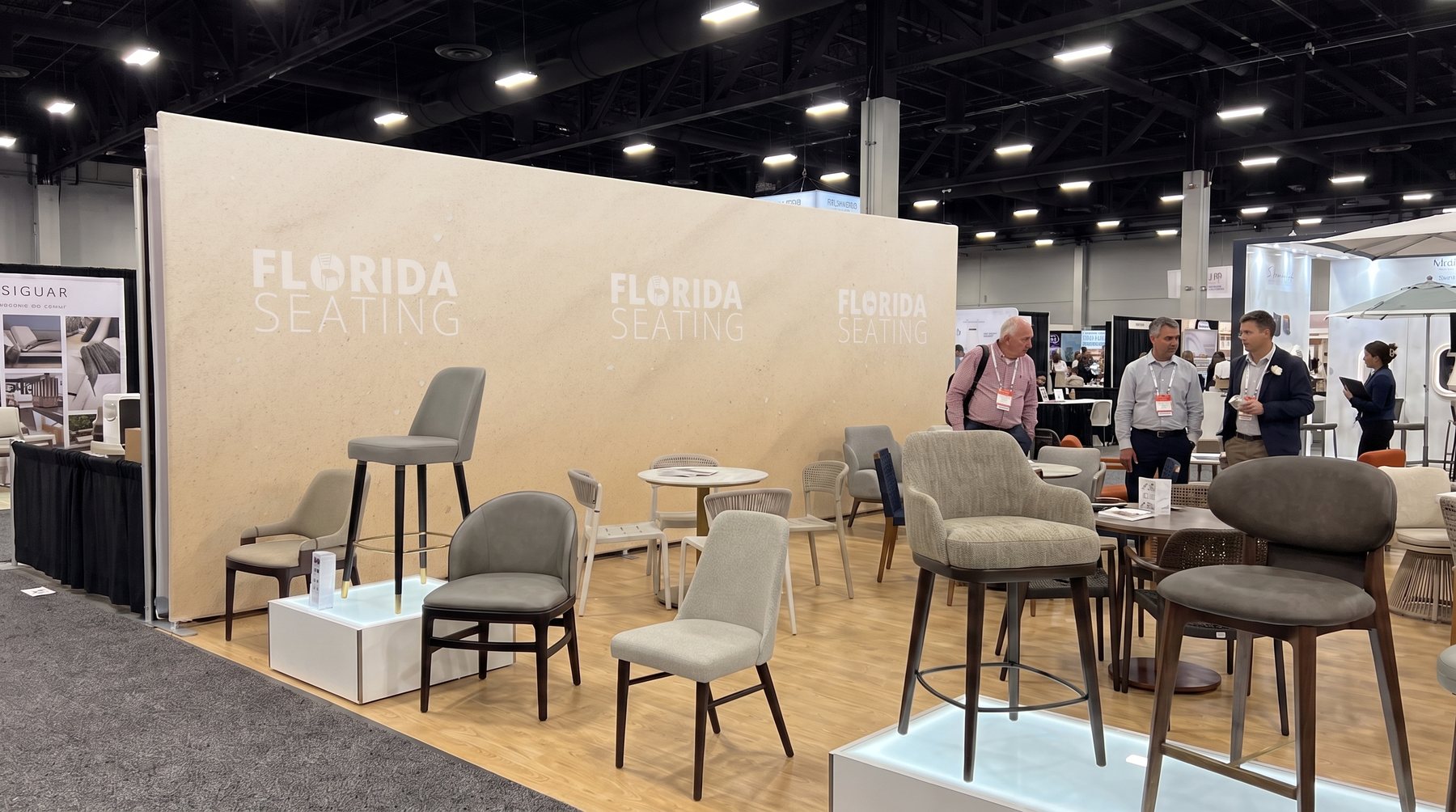 Second angle of the booth with the gradient sand wall and small off-white logos