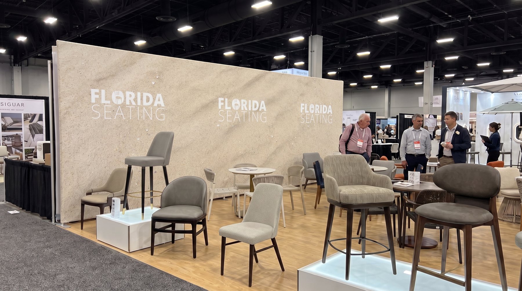 Second angle of the booth with the flat-colour sand-textured wall, strong grain