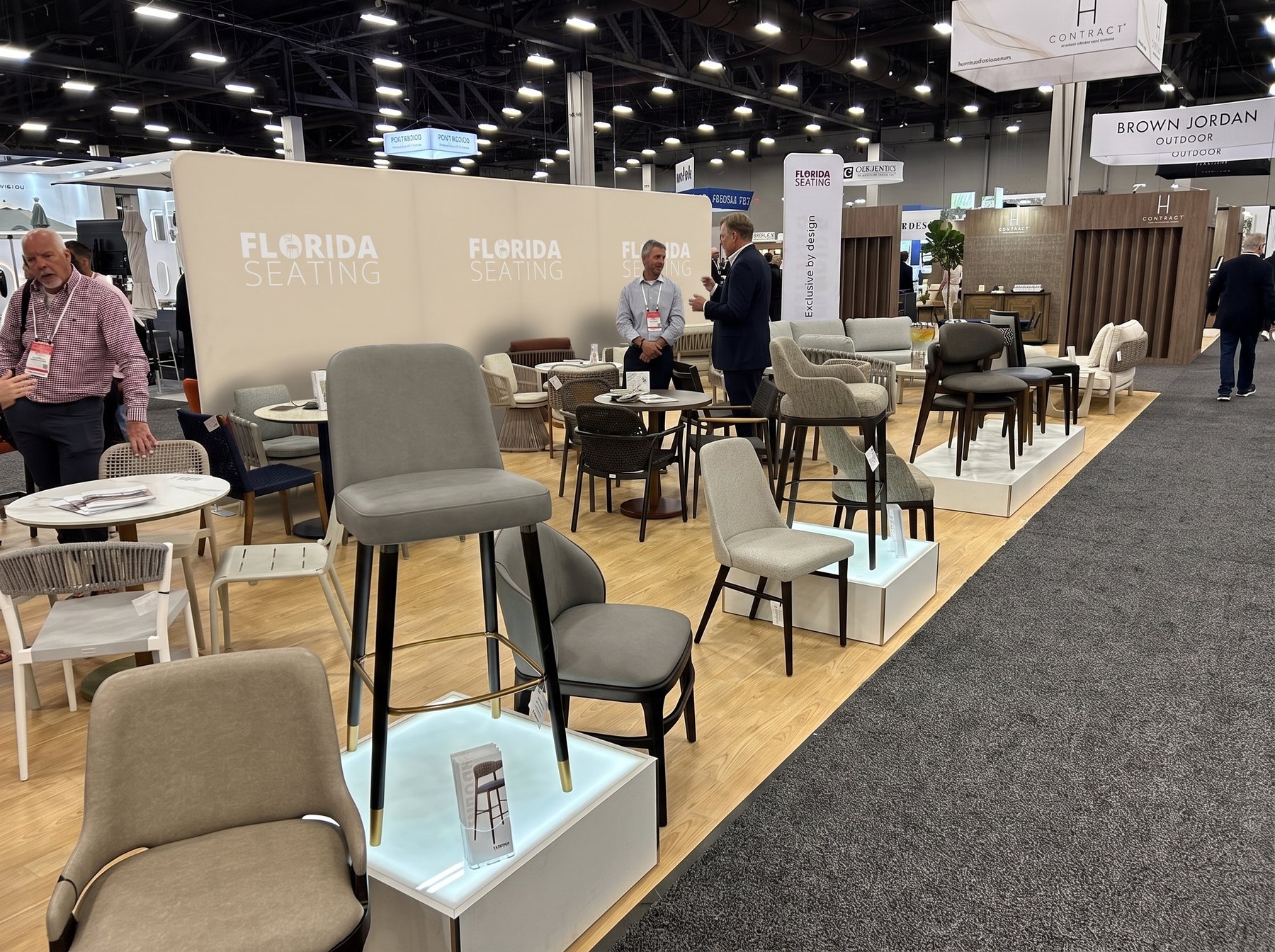 The HD Expo booth photo with a flat sand-coloured divider wall added along the back of the booth